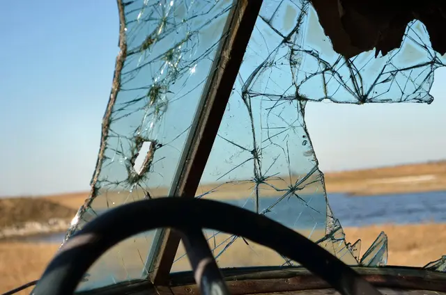 View through a broken windshield of an abandoned vehicle